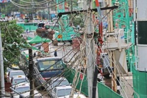   Electric power cable and wires tangled in a land post in Yangon. (Photo-Kyi Naing)