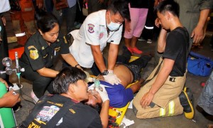 Rescue workers treat a victim after the accident, possibly caused by a fire retardant chemical at the headquarters of Thailand’s Siam Commercial Bank in Bangkok.    