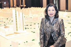 Chadatip Chutrakul, director of Iconsiam Co, poses with a model of the multi-use project scheduled to open next year.