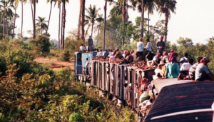 A train fully laden with passengers snakes its way through the jungle on the route from Phnom Penh to Sihanoukville in 1998