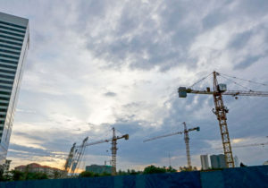 Construction site cranes stand against early morning clouds in Yangon on June 23. Photo: EPAConstruction site cranes stand against early morning clouds in Yangon on June 23.