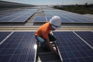 A technician checks out a solar array installed in Samut Prakan. Up to 19 solar farm licences have been revoked after operators failed to start commercial operations as scheduled. Some licence holders had done nothing to begin preparing their solar farms in the run-up to a June deadline.