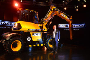 JCB Chairman Lord Bamford pictured with the newly-launched JCB Hydradig