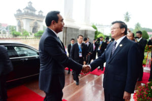 Lao Premier Thoungloune Sisoulith (right) greets visiting Prayut Chan-o-cha after the Thai prime minister arrived at the Lao Prime Minister's Office in Vientiane for a meeting on Tuesday. 
